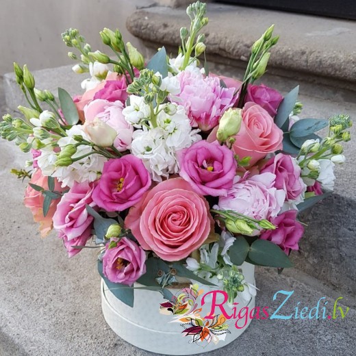 Composition of peony and matthiola flowers in a box