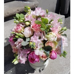 Composition of peony, roses and matthiola flowers in a box