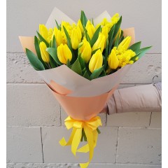 A bouquet of yellow tulips with mimosa
